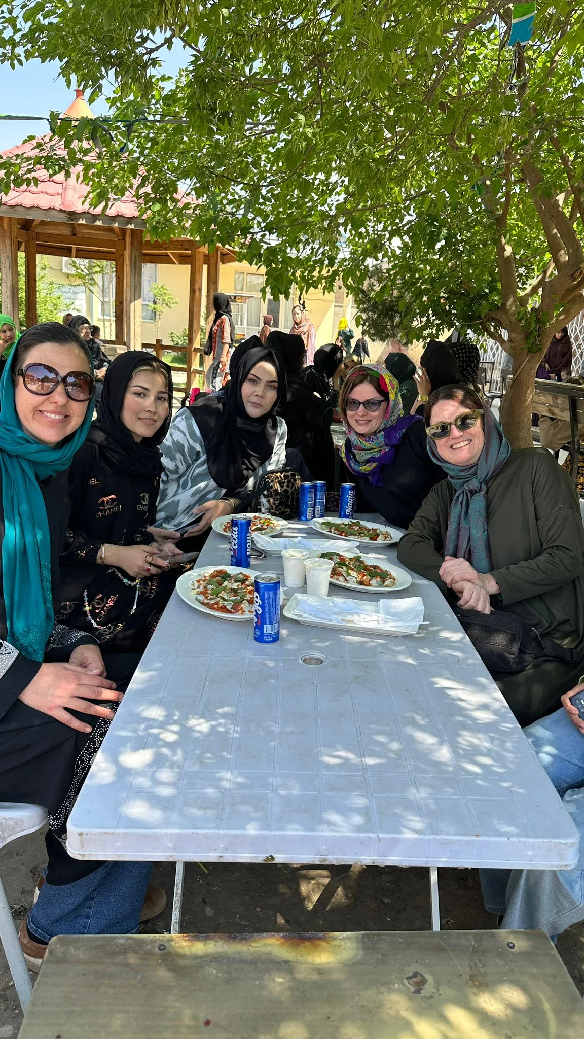 Female travelers with their local female tour guide in a women-only garden in Mazar-i-Sharif.